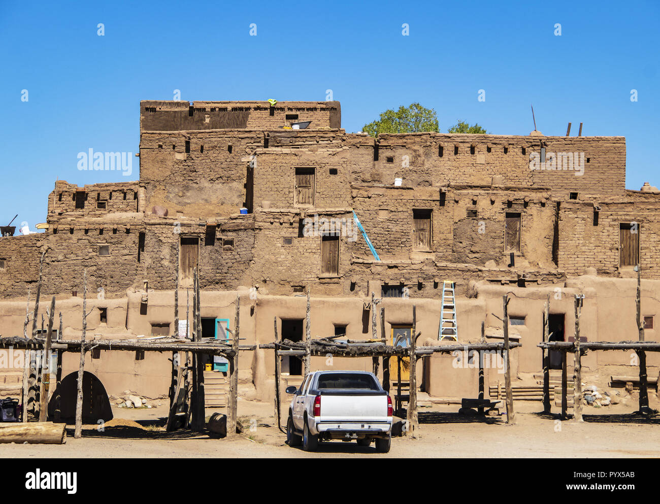 Southwestern Pueblo where Native Americans currently live during preparations for their annual harvest celebration - traditional ovens and drying rack Stock Photo