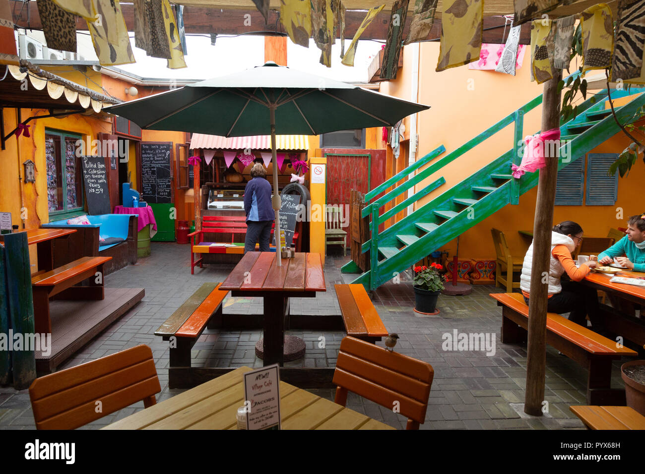 Swakopmund cafe -  people in a colourful cafe in the centre of Swakopmund, Namibia Africa Stock Photo
