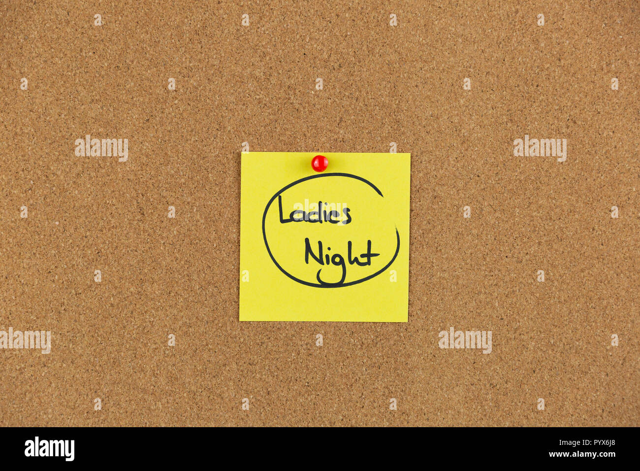 Note on a cork board with writing ladies night out. Stock Photo