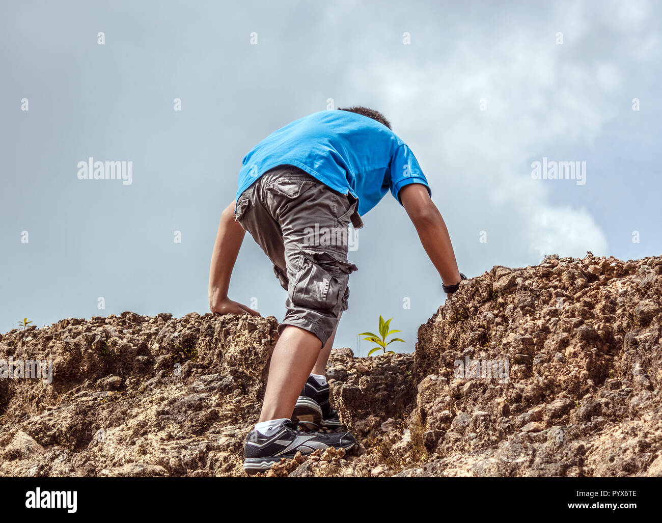 Young Man Climbing a Mountain Stock Photo