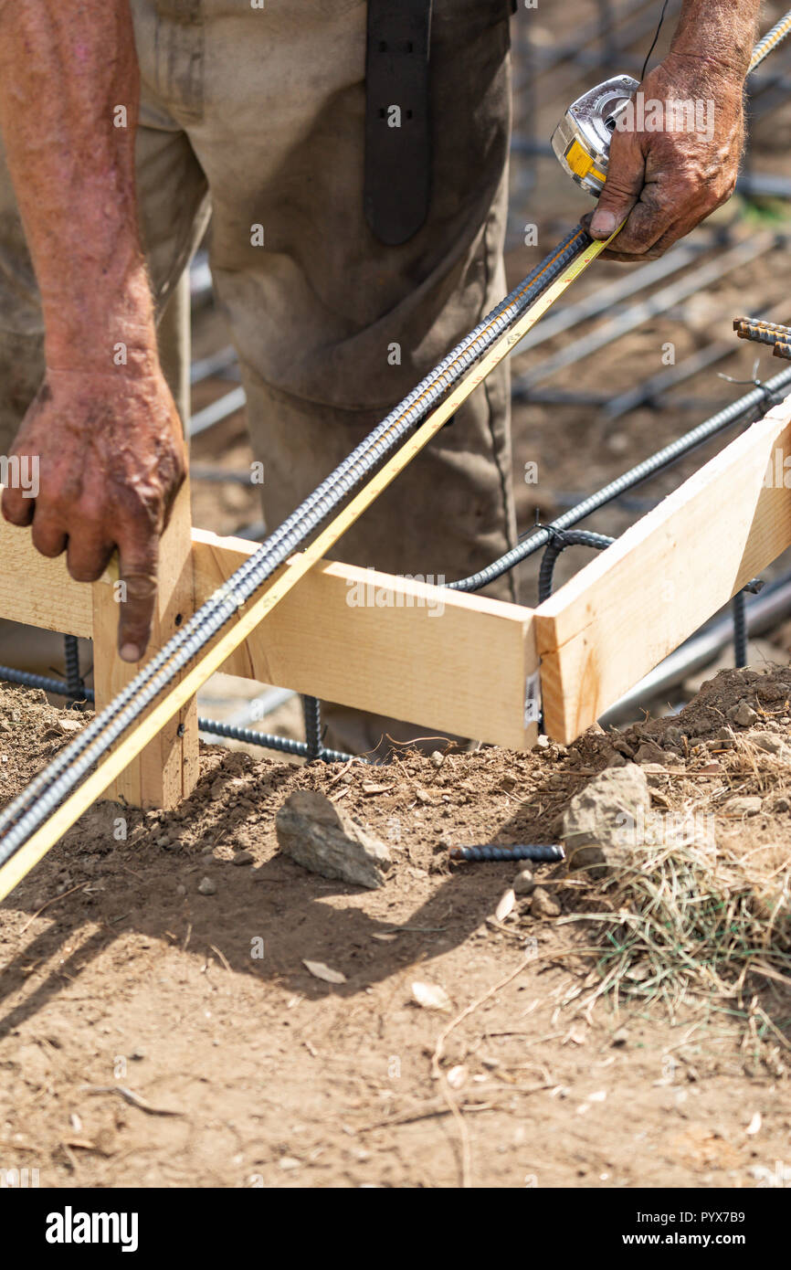 Worker Measuring Steel Rebar At Construction Site Stock Photo - Alamy
