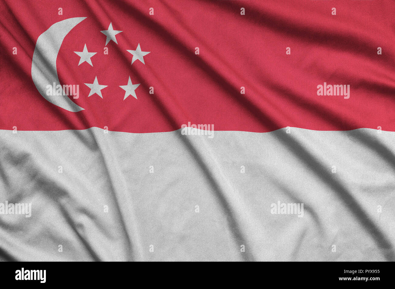Singapore flag is depicted on a sports cloth fabric with many folds. Sport team waving banner