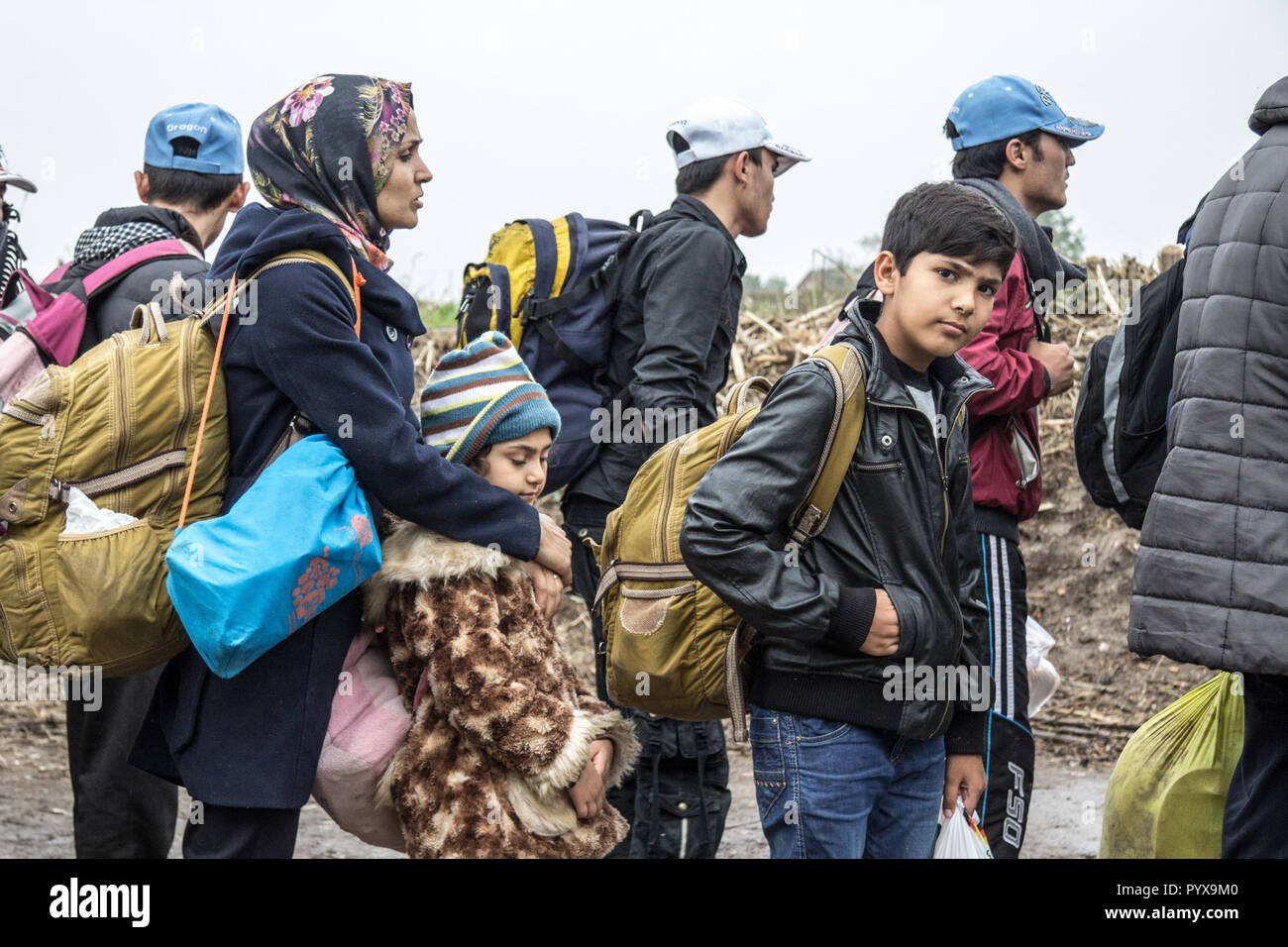 BERKASOVO, SERBIA - OCTOBER 17, 2015: Group of refugees, mainly children, waiting to cross the Croatia Serbia border, between the cities of Bapska and Stock Photo