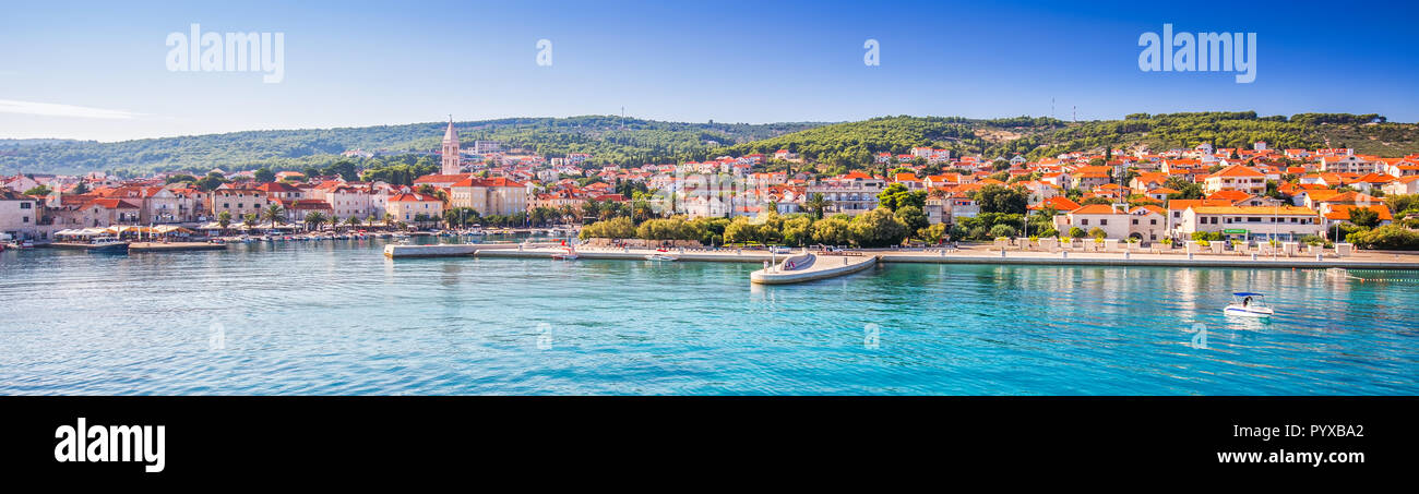 Harbour in Supetar town on Brac island with palm trees and turquoise clear ocean water, Supetar, Brac, Croatia, Europe Stock Photo
