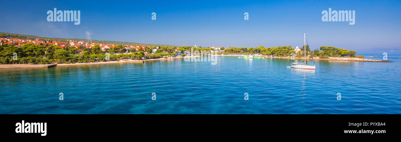 Harbour in Supetar town on Brac island with palm trees and turquoise clear ocean water, Supetar, Brac, Croatia, Europe. Stock Photo