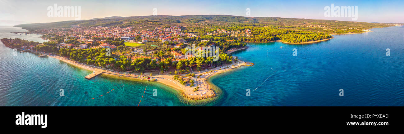 Aerial view of seaside promenade in Supetar town on Brac island with palm trees and turquoise clear ocean water, Supetar, Brac, Croatia, Europe. Stock Photo