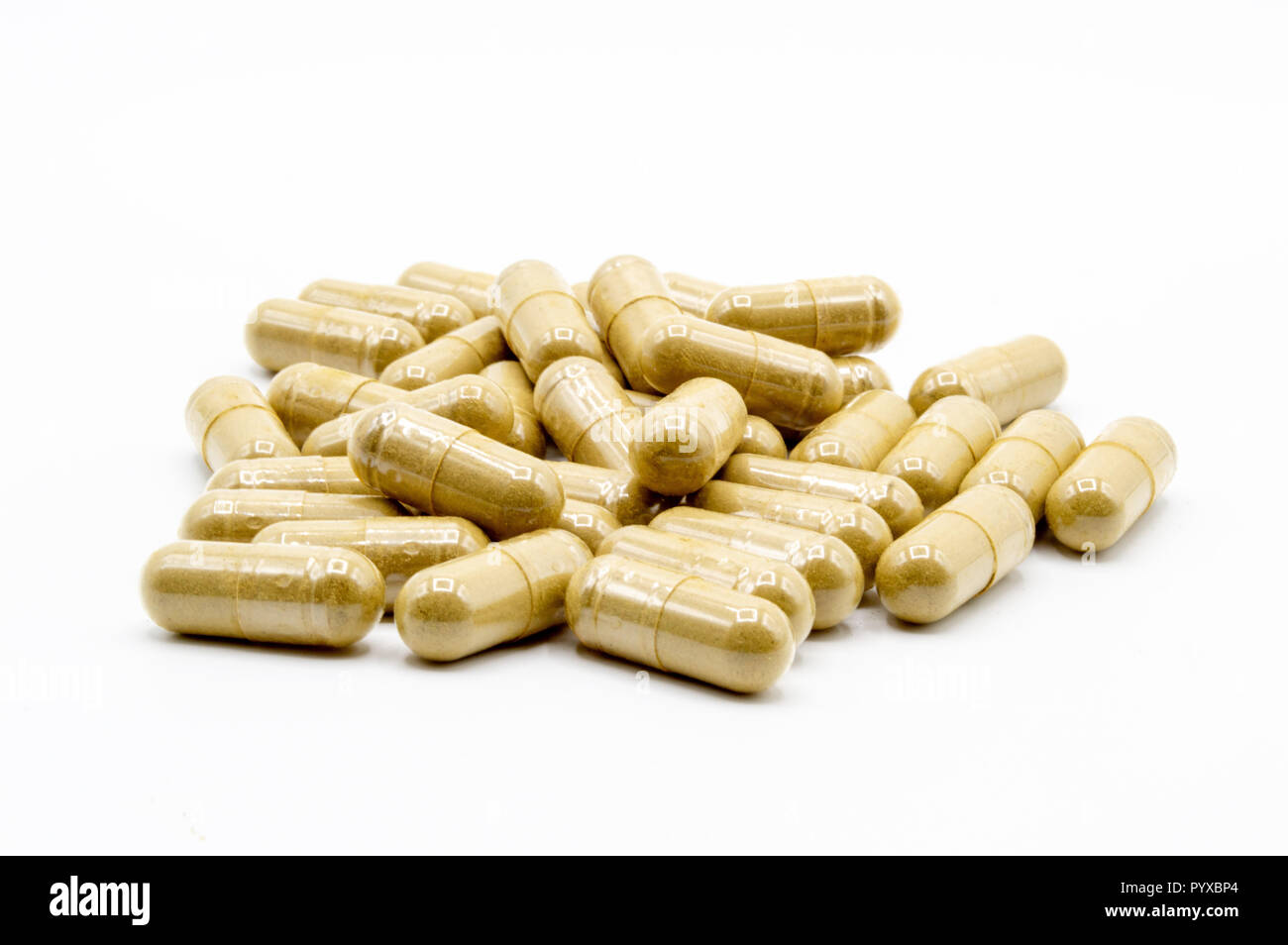 Green Kratom capsules on white background with all pills in focus. Stock Photo