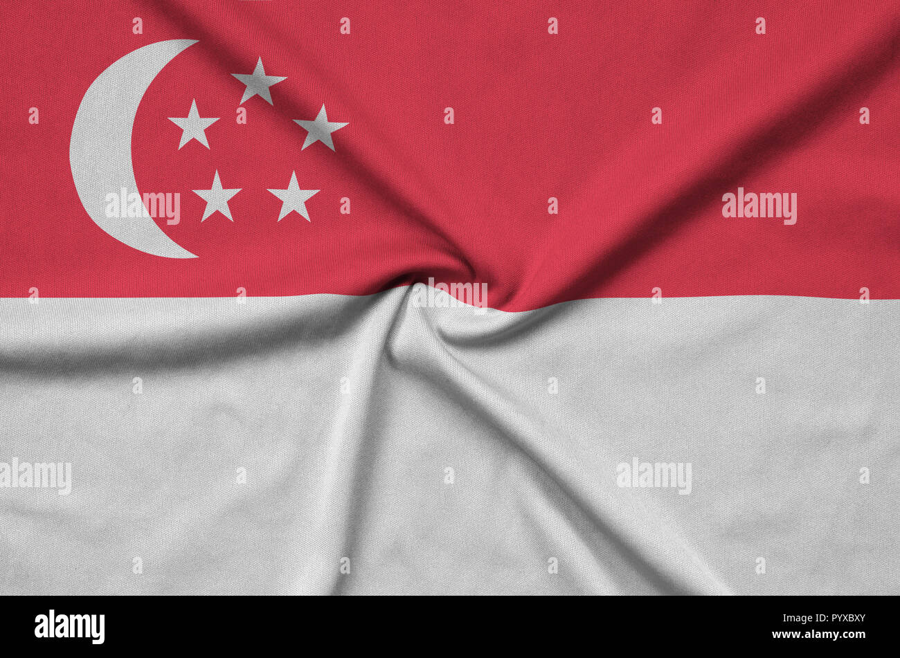 Singapore flag is depicted on a sports cloth fabric with many folds. Sport team waving banner