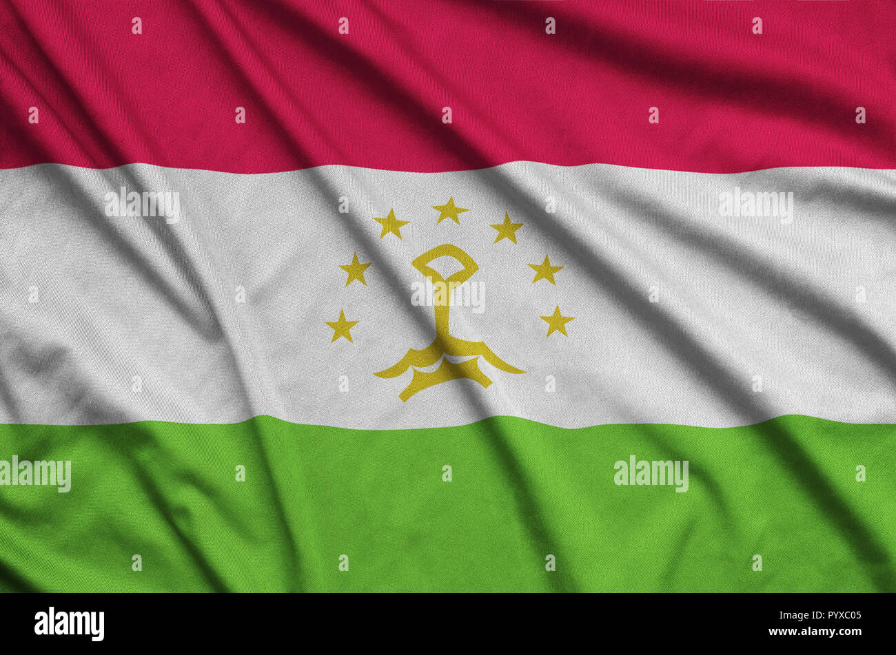 Tajikistan flag  is depicted on a sports cloth fabric with many folds. Sport team waving banner Stock Photo