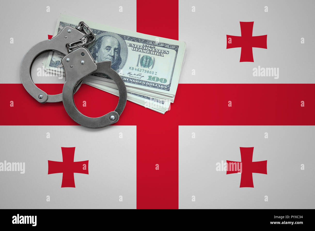 Georgia flag  with handcuffs and a bundle of dollars. The concept of breaking the law and thieves crimes. Stock Photo