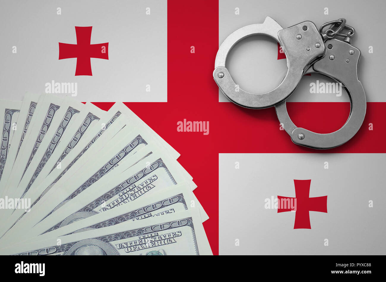 Georgia flag  with handcuffs and a bundle of dollars. The concept of illegal banking operations in US currency. Stock Photo
