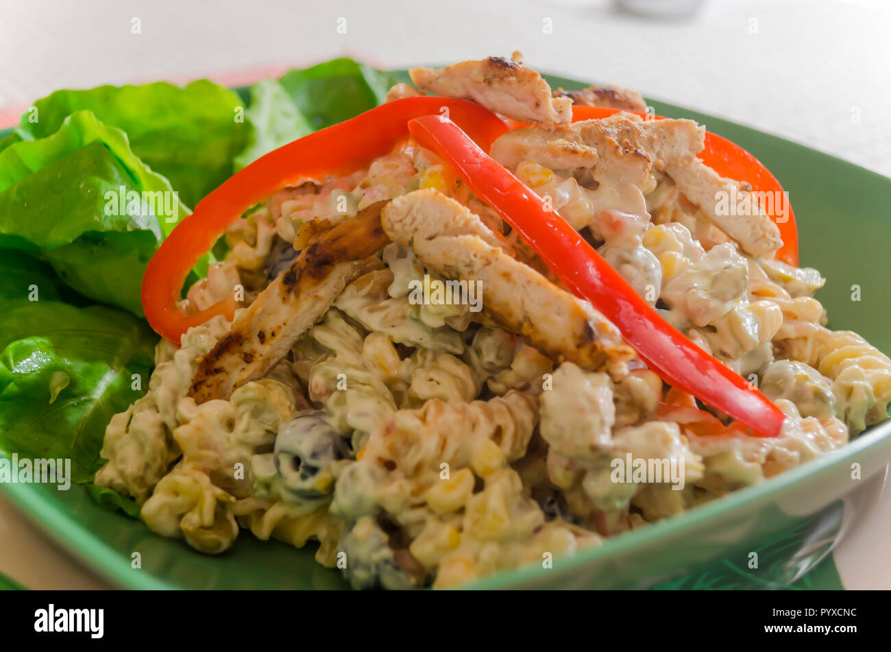 Cold summer pasta with grilled or grilled chicken is a dish delight with an exquisite flavor due to the combination of al dente pasta, fresh vegetable Stock Photo