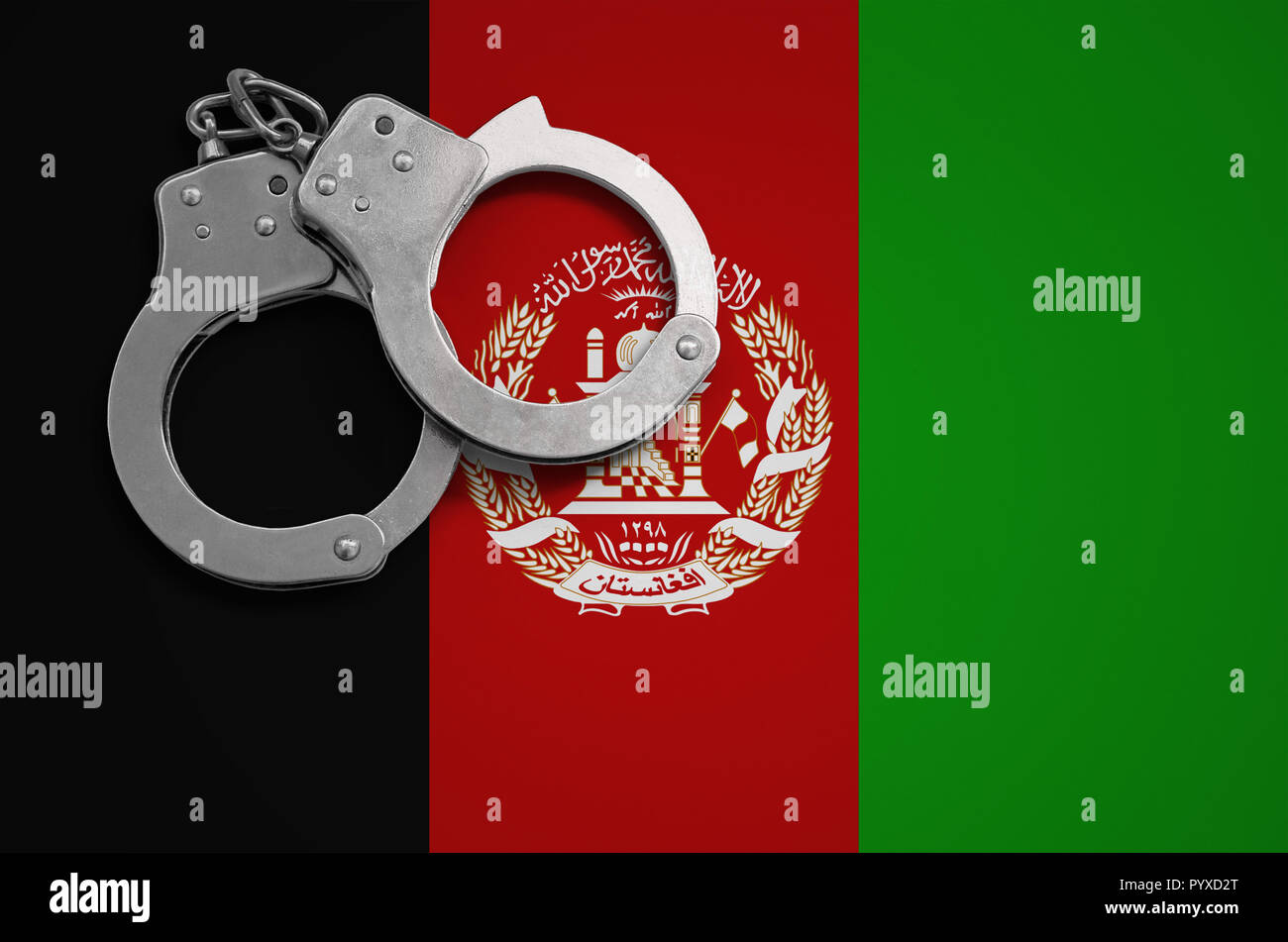 Afghanistan flag and police handcuffs. The concept of crime and offenses in the country. Stock Photo