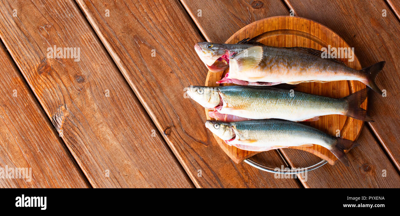 Banner Fresh Sea Fish Catch Lies On A Cutting Board On A Wooden
