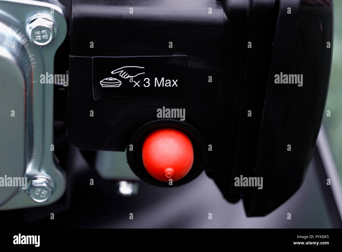 Detail of the choke button of a mower's engine with its warning Stock