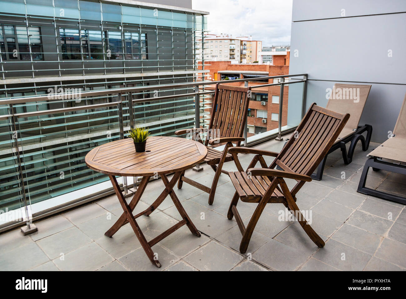 Wooden folding chairs and table on a hotel balcony in Malaga, Spain Stock Photo