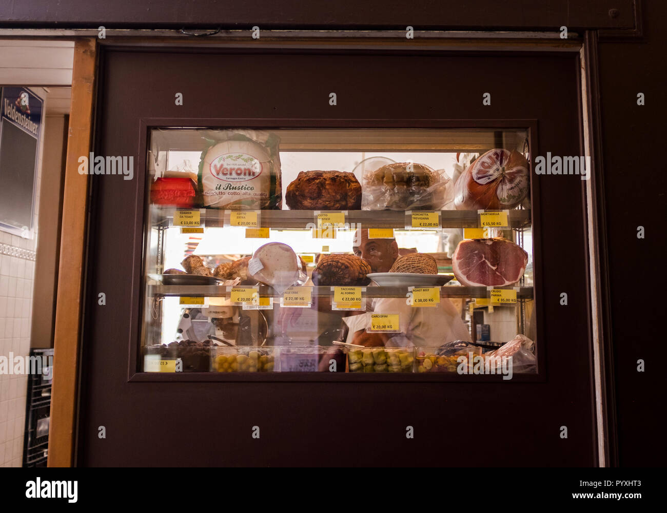 Shop window displaying meat and other foods on the streets of Venice, Italy Stock Photo