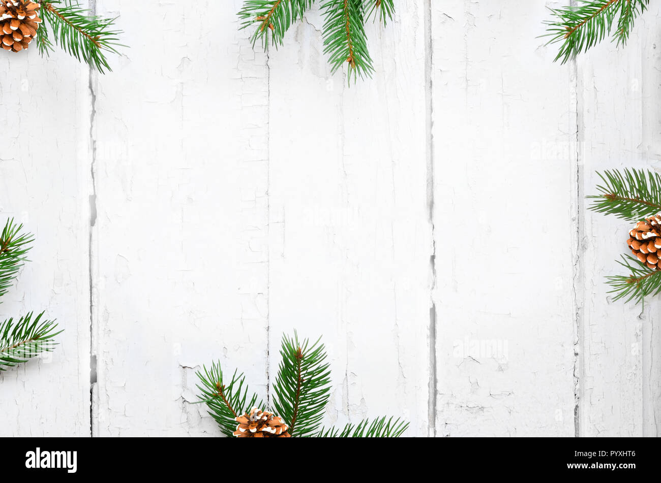 Christmas background with fir branches, pinecones on the old wooden ...