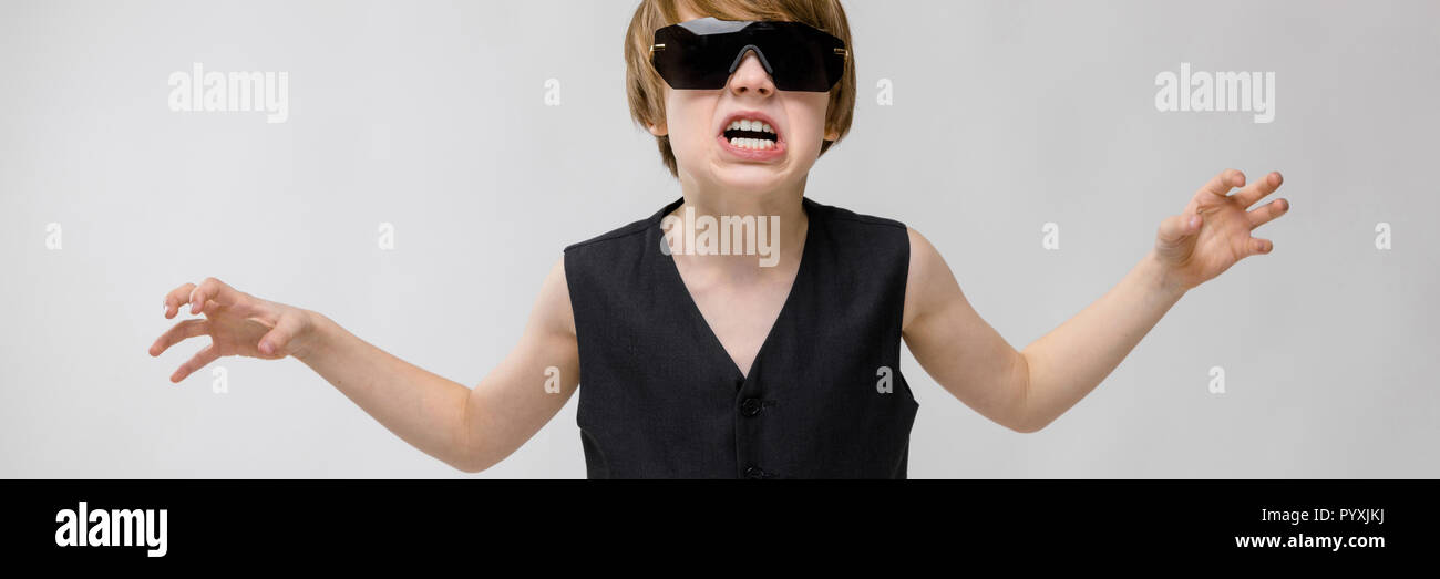 Portrait of adorable funny little boy standing in studio with ...