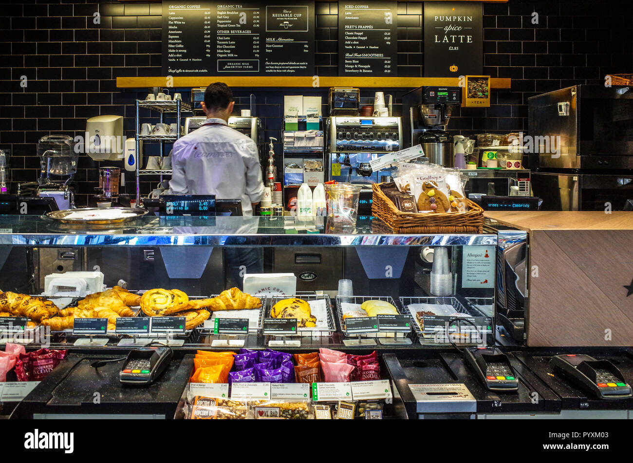 Pret a Manger service counter with Barista making coffee - Pret is a fresh food fast food restaurant chain Stock Photo