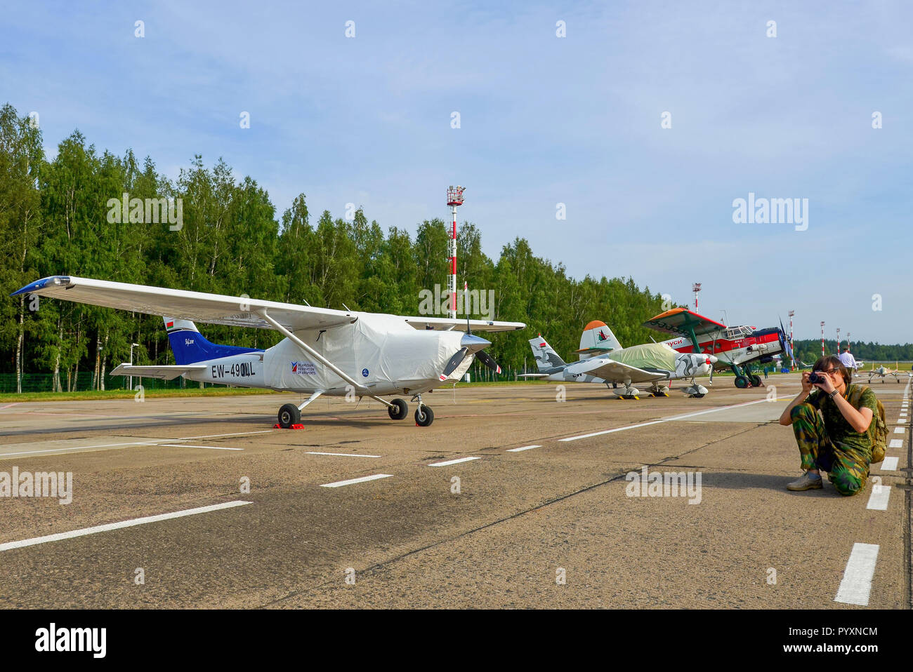 Belarus, Lipki Airfield Aeroclub 07/01/2018: Aviation photographer with a camera takes pictures of airplanes. PHOTOSESSION. Air Force of the Republic  Stock Photo