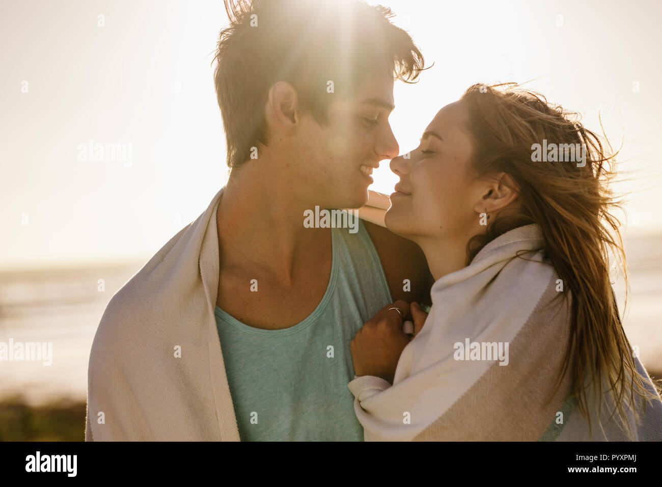 Close up of a happy couple in romantic mood standing close at the ...