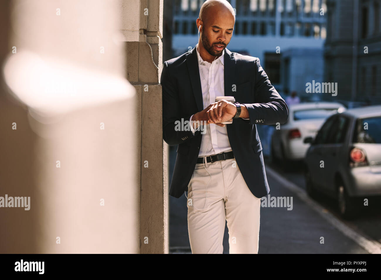 Waiting young african man checking hi-res stock photography and images ...