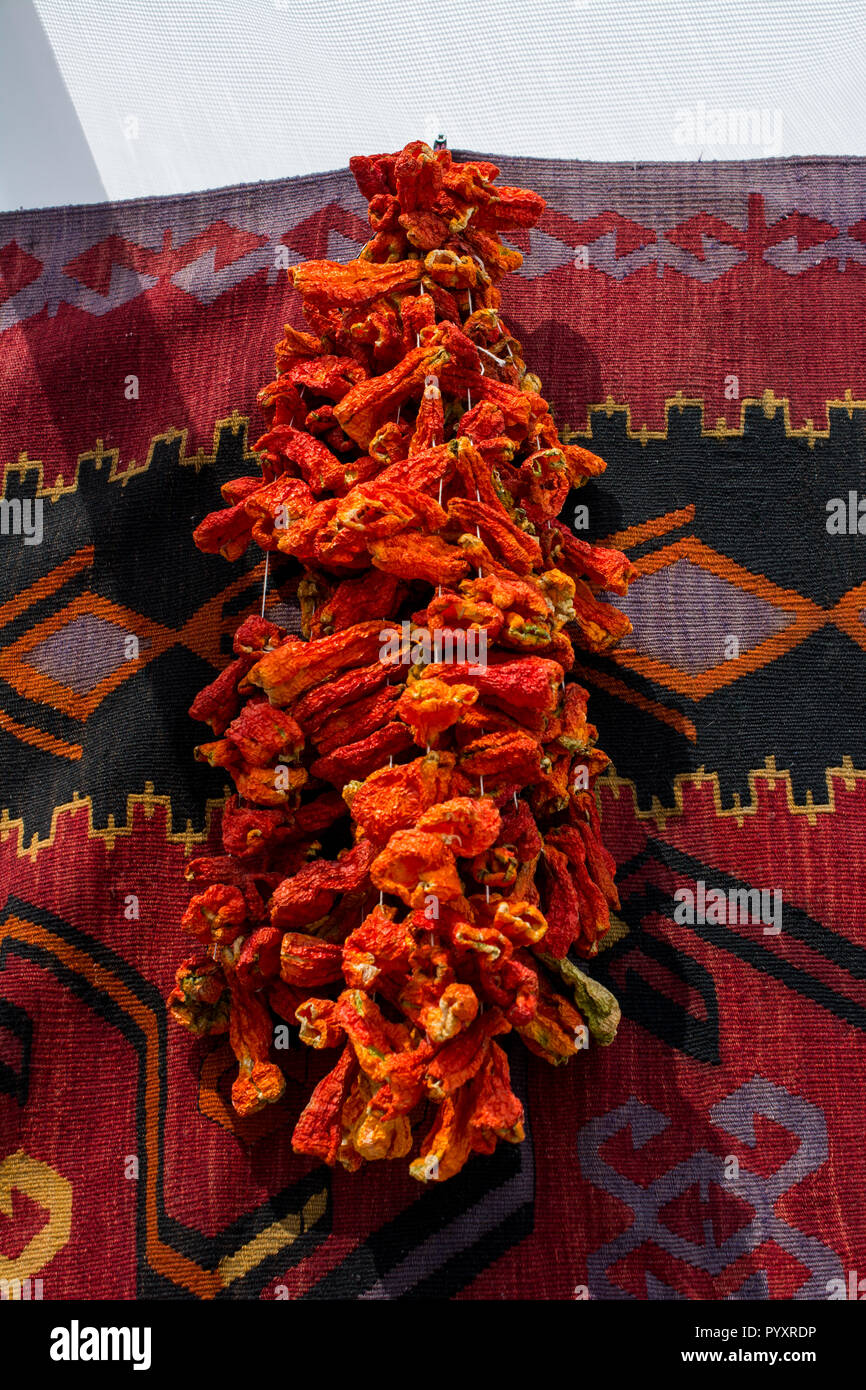 Bundles of red peppers dry in the sun Stock Photo - Alamy
