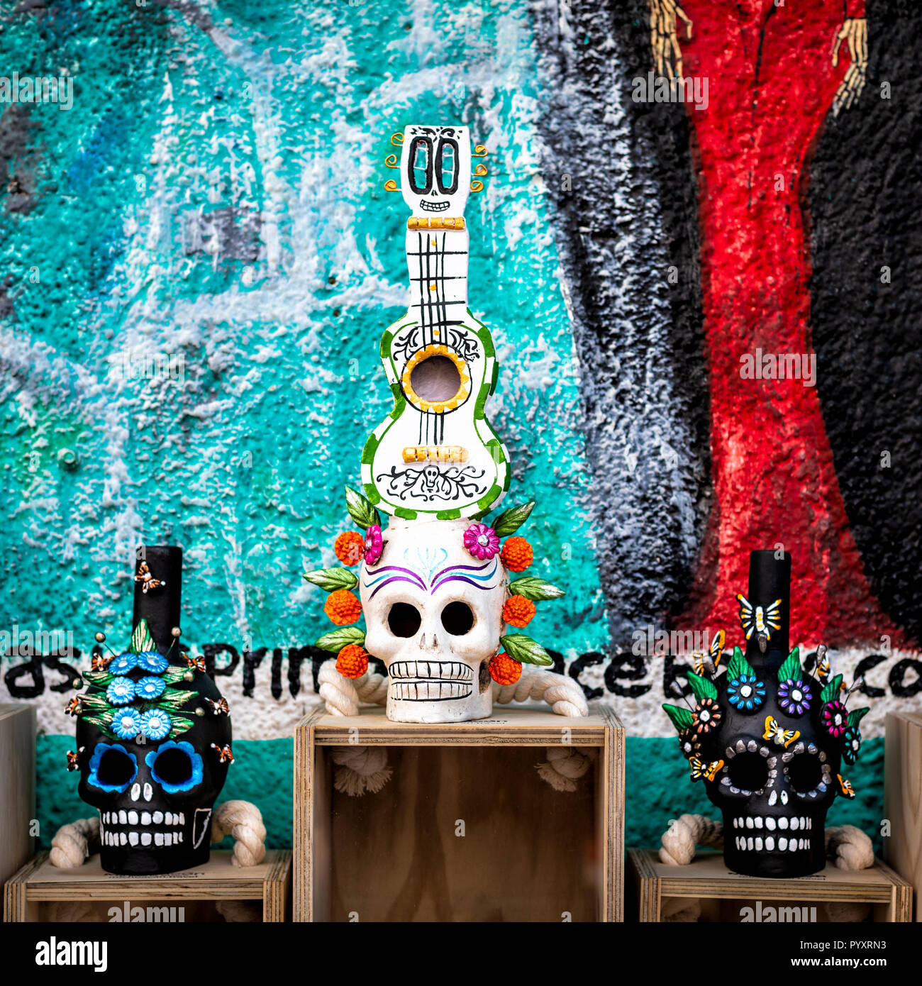 A guitar similar to the one in the movie Coco sits atop a white skull in a Capula, Mexico market. Stock Photo