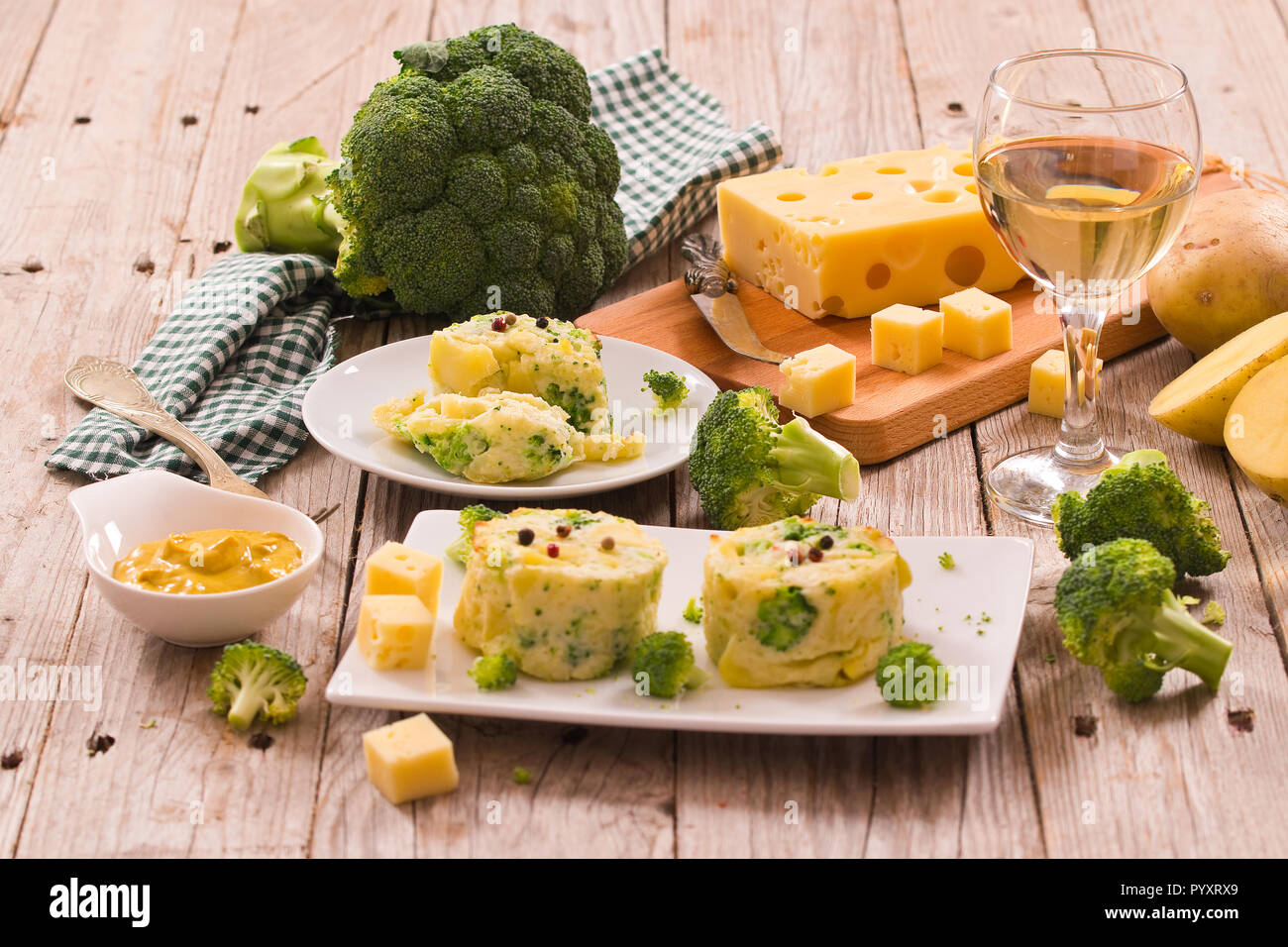 Potato gratins with broccoli florets Stock Photo Alamy