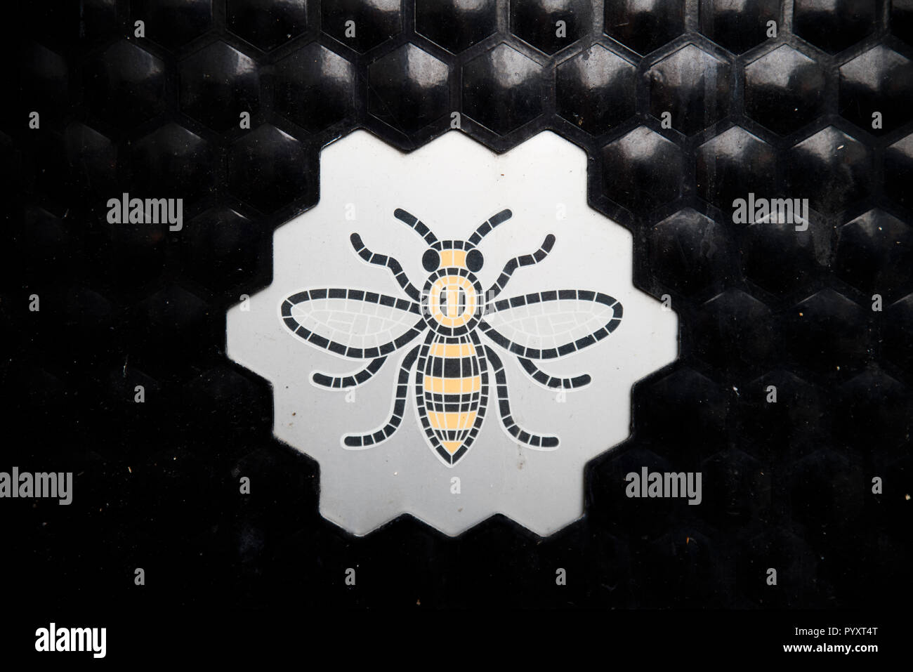 Worker Bee symbol on the side of a Manchester trash can. The bee is a symbol of hard work and resilience against terrorism. Stock Photo