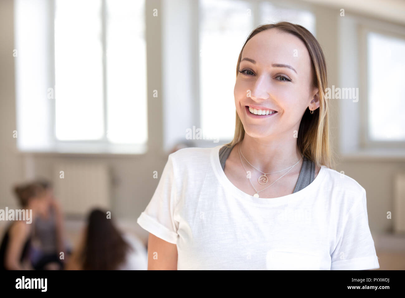 Fitness instructor female smiling looking at camera at workout s Stock Photo