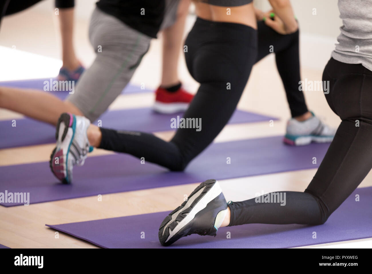 Close up of people legs sportive people doing lunge Stock Photo