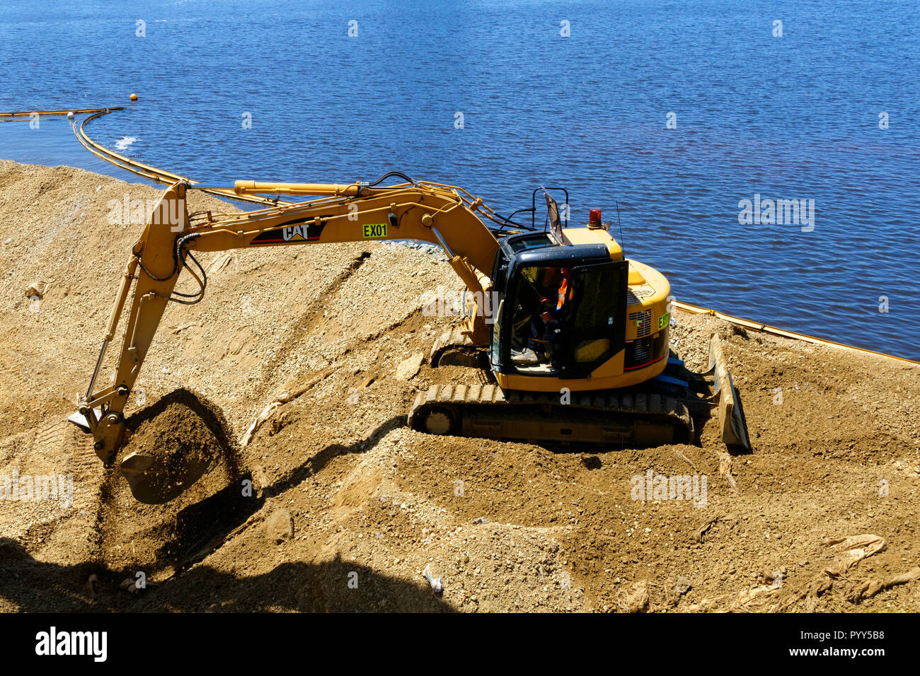 Excavation machine operating on edge of Swan River, Perth, Western Australia Stock Photo