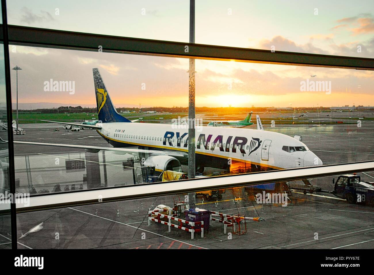Ryanair passenger plane jet aircraft airplane on runway apron between flights seen from boarding gates of Dublin Airport Terminal Building, Ireland Stock Photo
