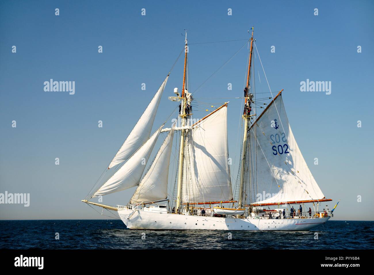 HSwMS Falken. Tall ship training schooner of the Swedish Navy under sail in the Baltic Sea. Crew aloft working sails during course tacking manoeuvre Stock Photo