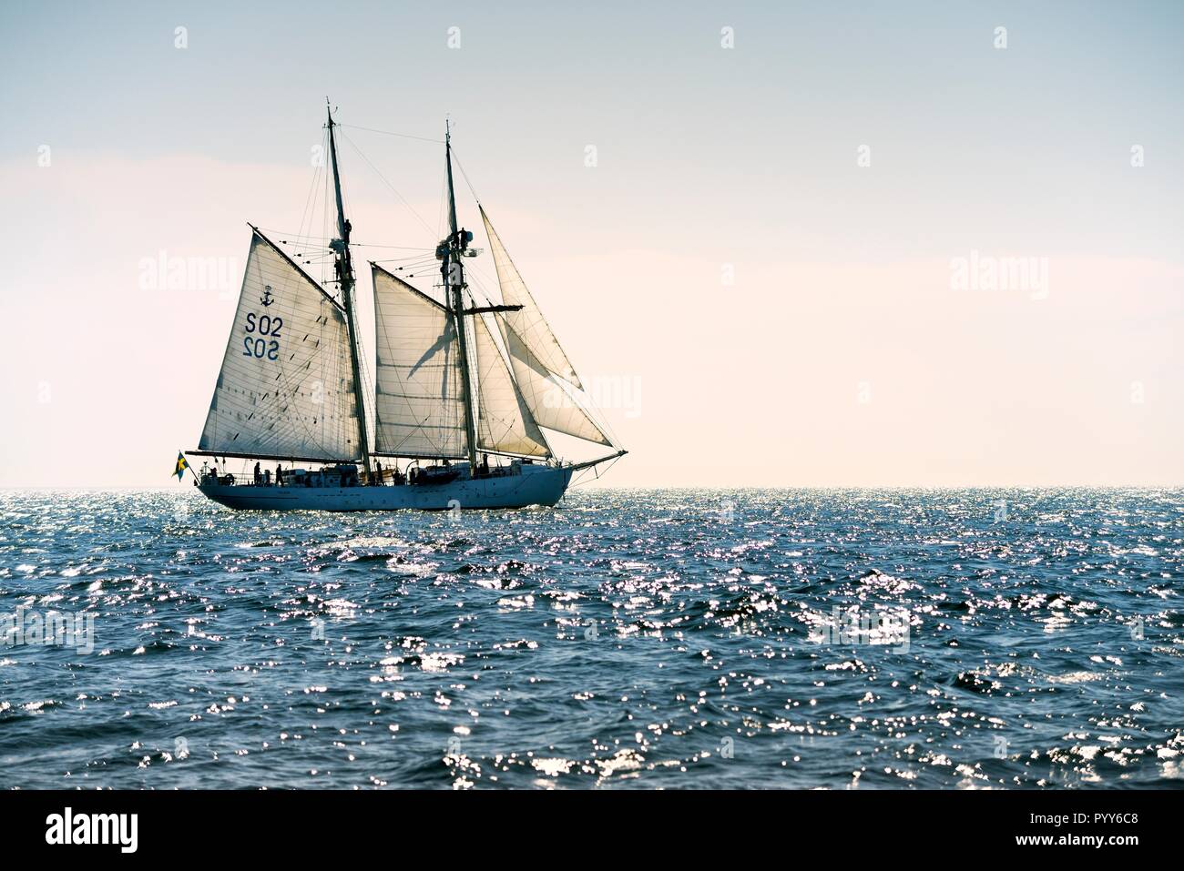 HSwMS Falken. Tall ship training schooner of the Swedish Navy under sail in the Baltic Sea. Crew aloft working sails during course tacking manoeuvre Stock Photo