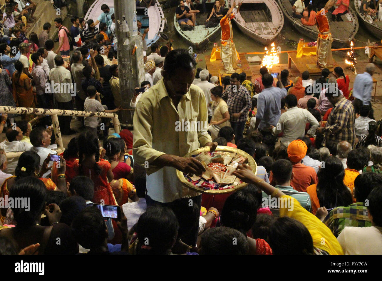 The offering during the famous fire (?) ritual and procession in Varanasi. Taken in India, August 2018. Stock Photo
