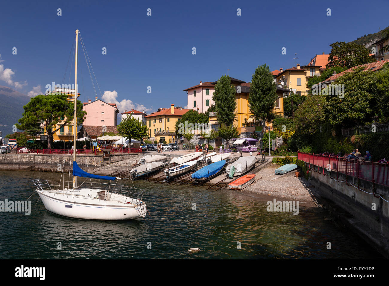 Yacht moored in Varenna harbour on Lake Como, Italy Stock Photo