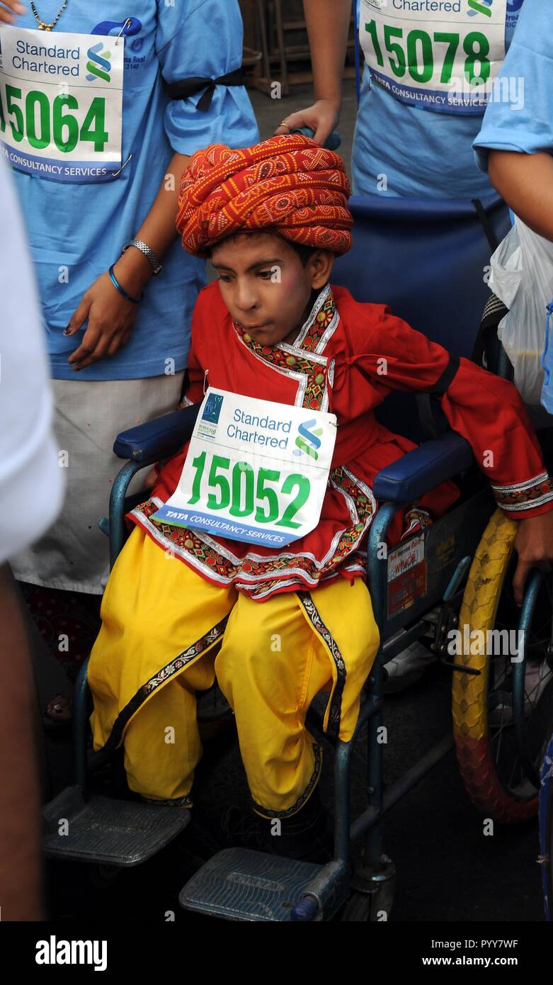 disabled wheelchair participant boy in fancy dress in Marathon, Mumbai, Maharashtra India Stock Photo