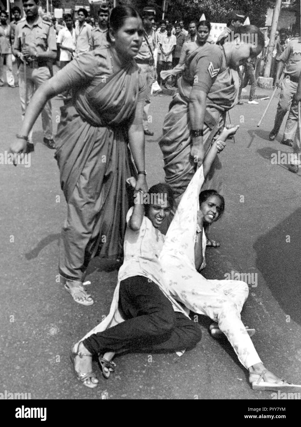 Police women arresting protesting girls, Mumbai, Maharashtra, India, Asia, 1900s Stock Photo