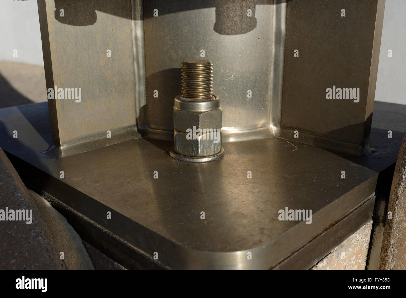 Stainless steel anchor bolt and nuts securing welded and fabricated