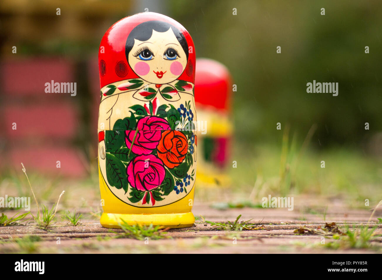 Matreshka dolls, matreshka on ground. Matrioshka Is Folks Cultural Symbol Of Russia. Wooden Doll Matryoshka Stock Photo