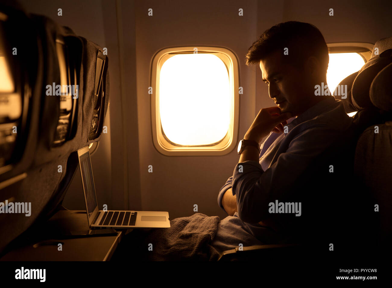 Young men by plane Stock Photo