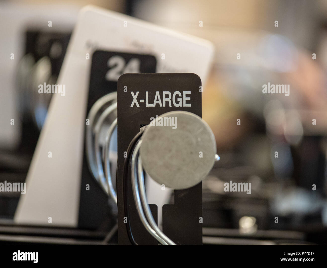 X-large end cap sign on steel clothes hanging rack with hangers in ...