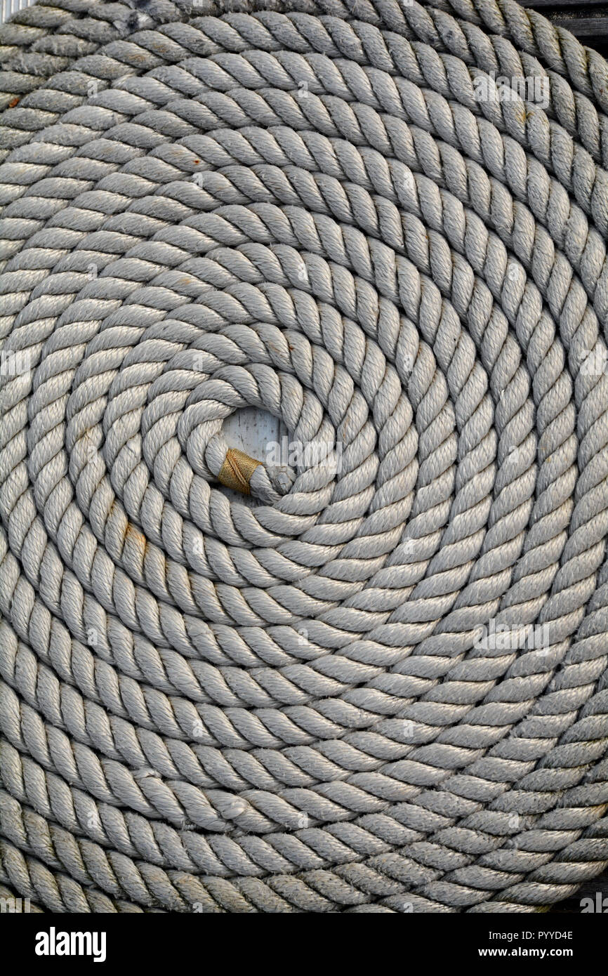A neatly coiled rope at a Marina Stock Photo - Alamy