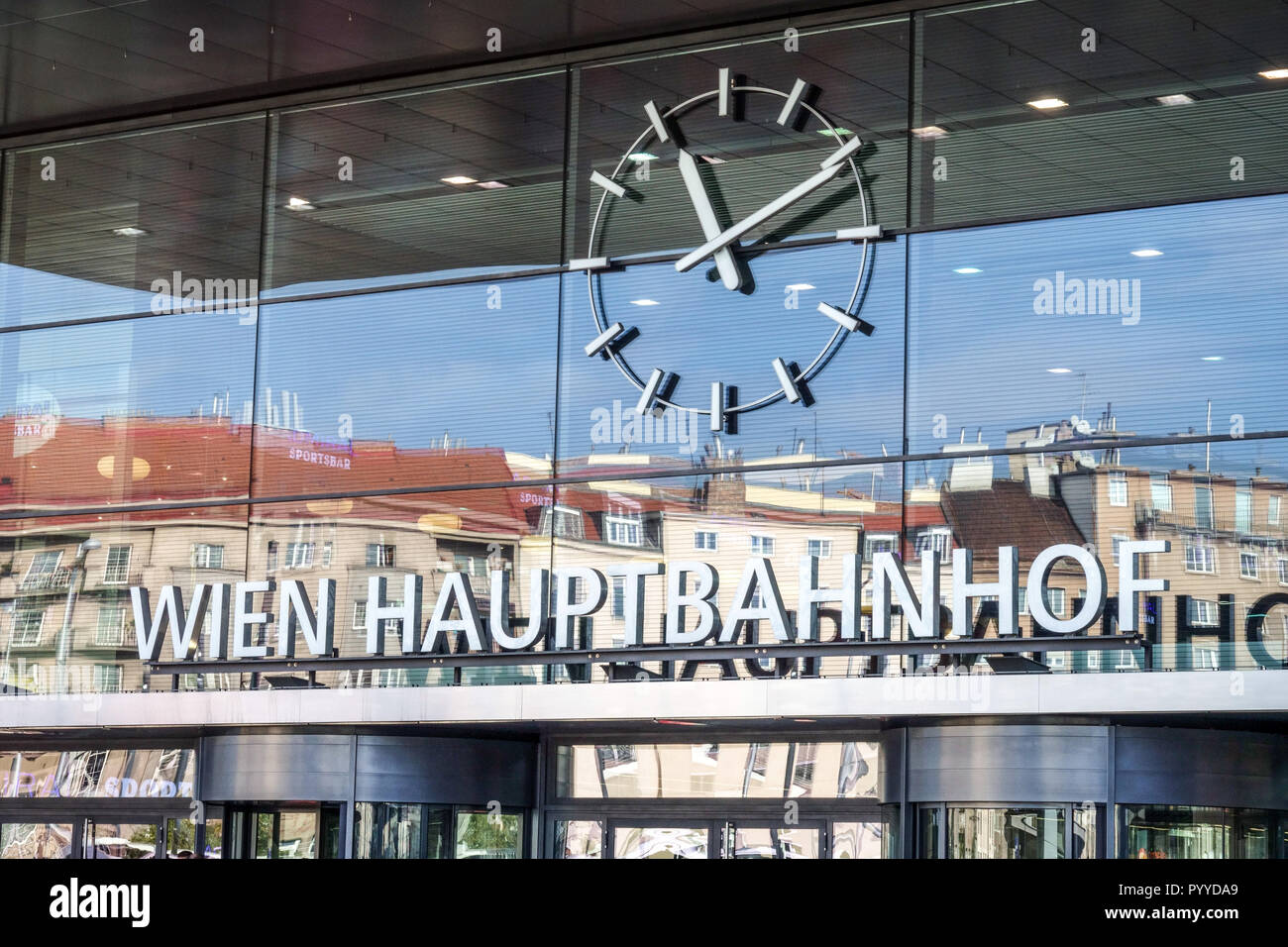 Vienna main railway station with clock and reflection of buildings large clocks Stock Photo