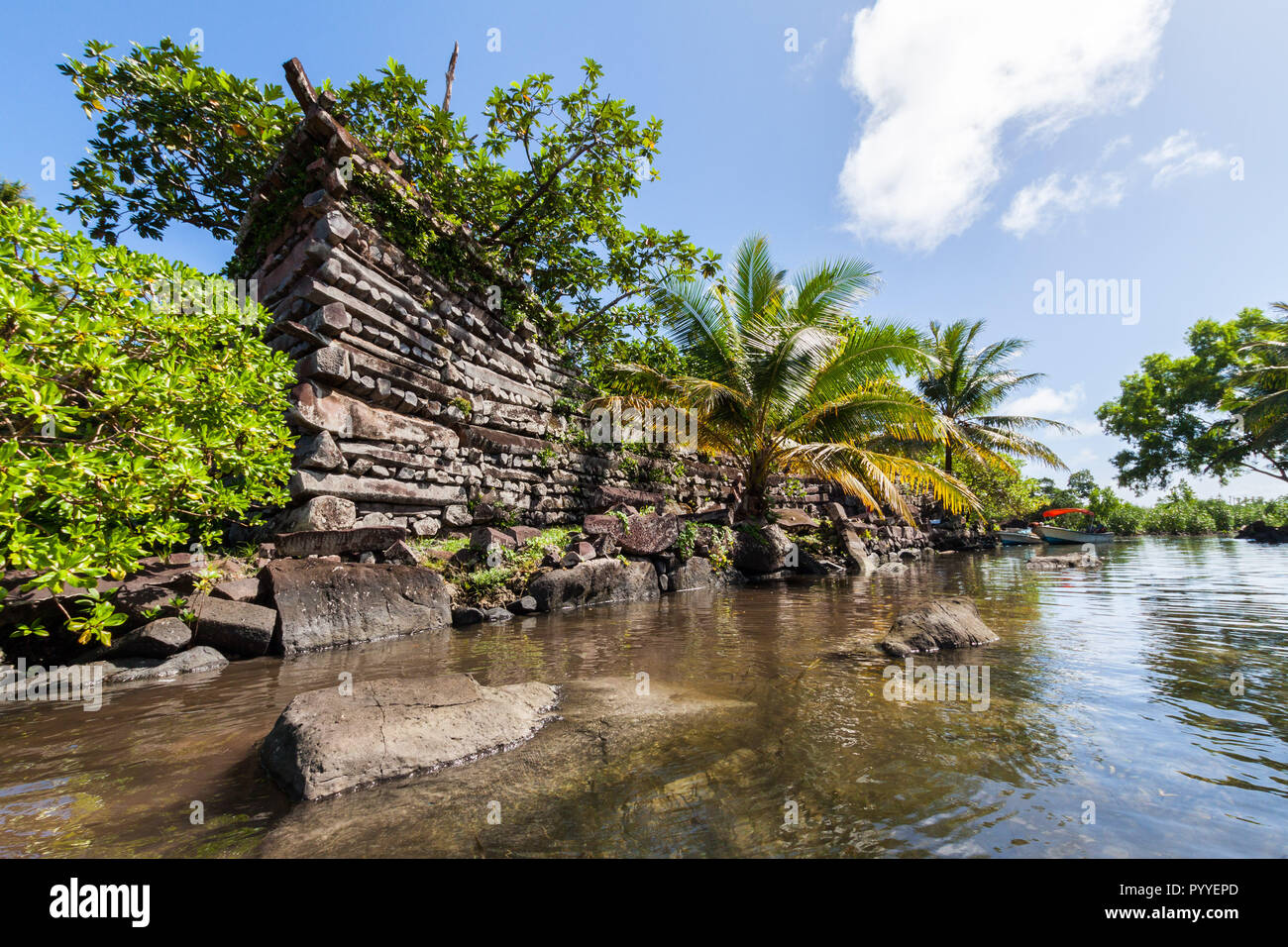 A channel and town walls in Nan Madol - prehistoric ruined stone city built of basalt slabs. Ancient walls were built on coral artificial islands in the lagoon of Pohnpei, Micronesia, Oceania Stock Photo