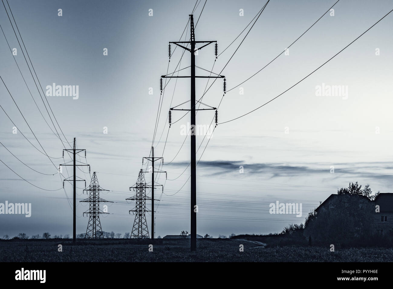 High-voltage towers on the evening sky background Stock Photo - Alamy