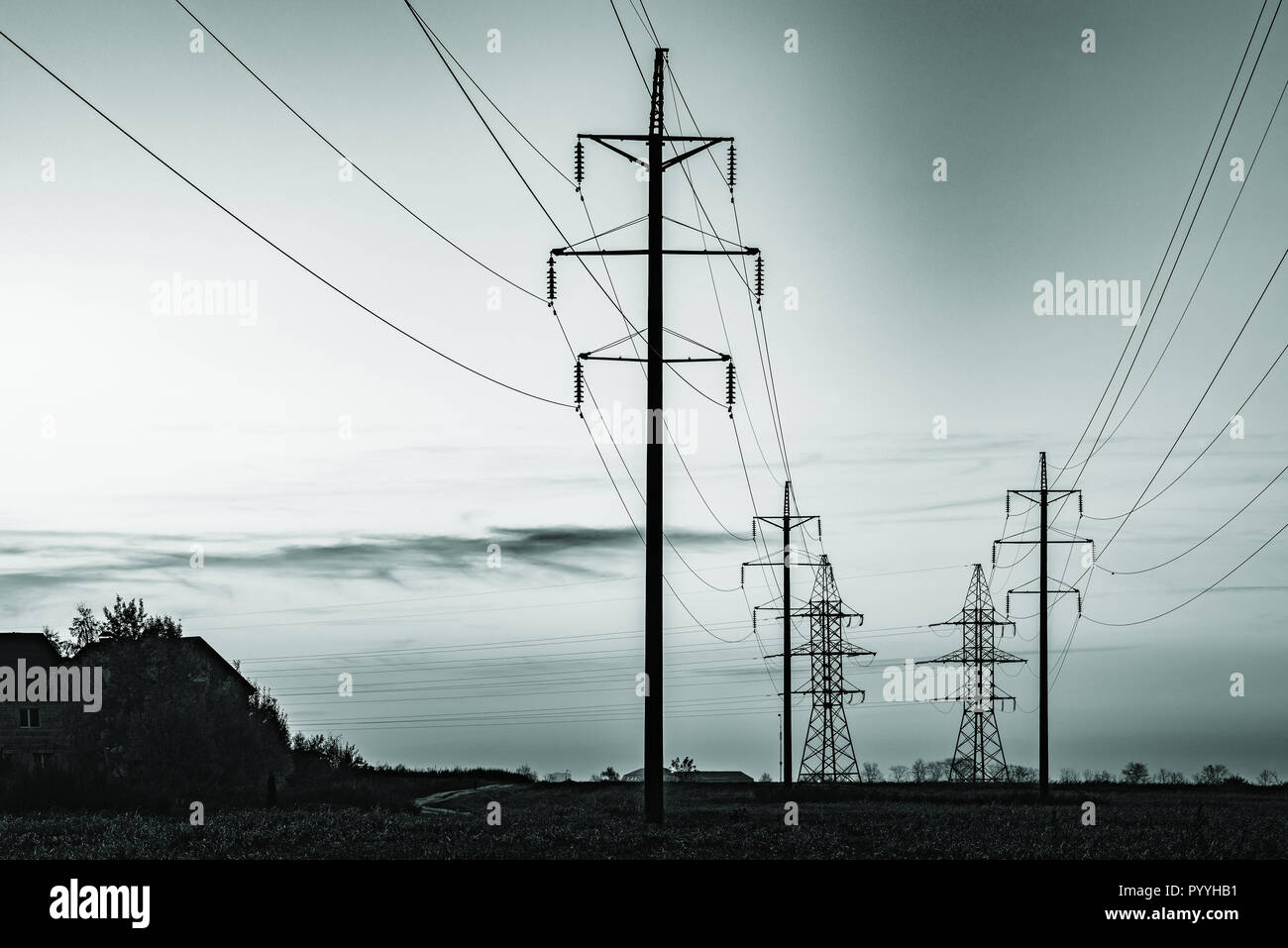 High-voltage towers on the evening sky background Stock Photo - Alamy